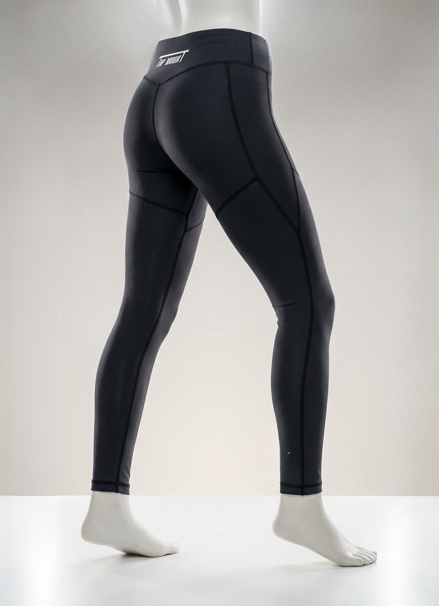 Rear view of Youth Girls BJJ Spats in black compression fabric with reinforced stitching and white Top Mount logo.