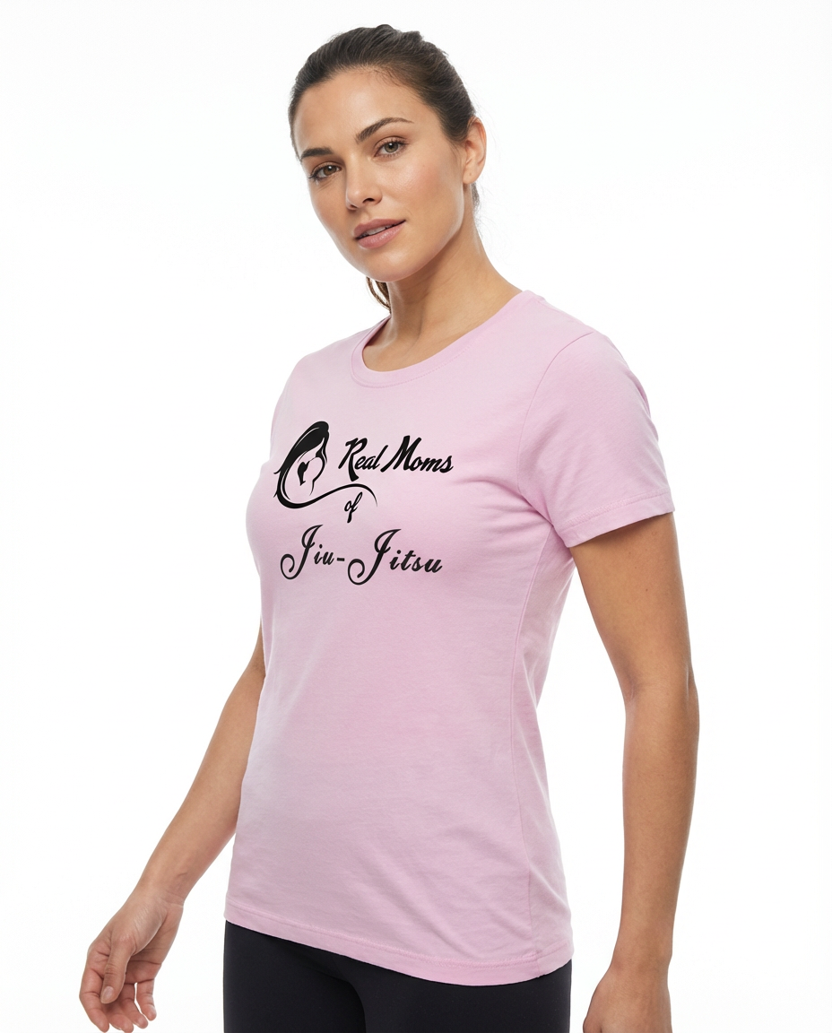 Woman models a light pink Jiu-Jitsu Mom T-Shirt featuring 'Real Moms of Jiu-Jitsu' text and a mother-child graphic.