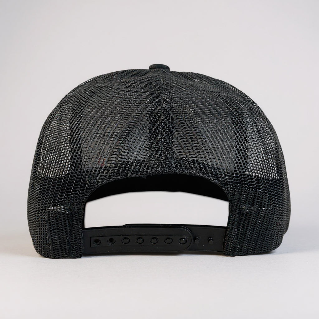 Rear view of Top Mount BJJ Warrior black trucker hat with breathable mesh and adjustable snapback closure.