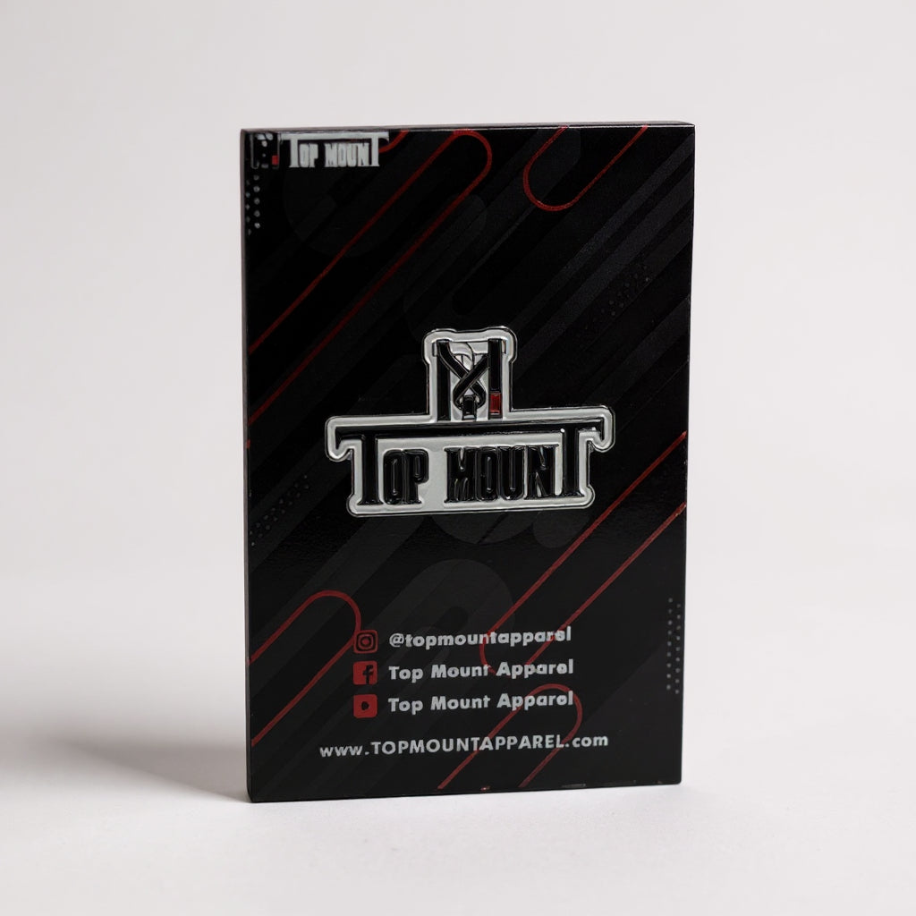 BJJ Enamel Lapel Pin with black and white Top Mount logo on a red-accented Jiu Jitsu accessory backing card.