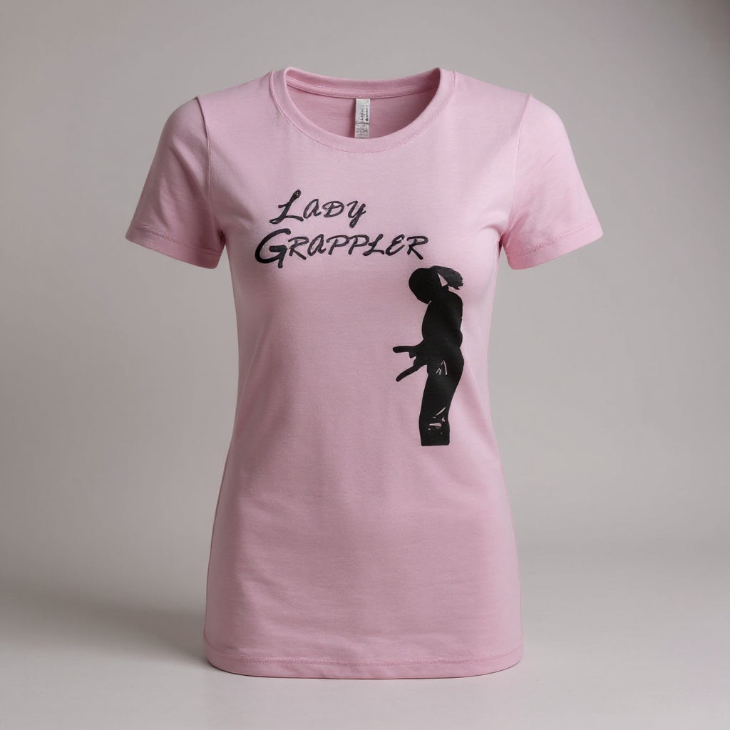 Light pink Lady Grappler women's BJJ graphic tee featuring a lady warrior silhouette tying her belt on the front.