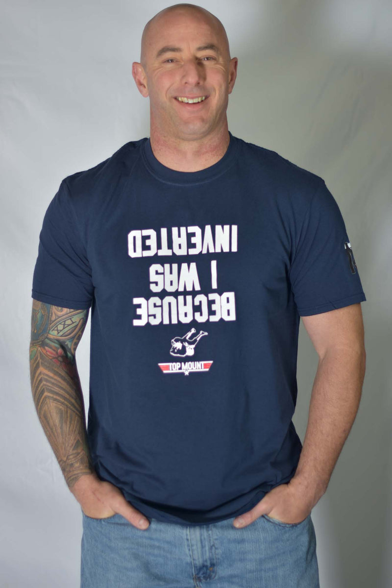 Man in navy Because I Was Inverted BJJ Tee with upside-down white text and Top Mount Apparel Jiu Jitsu logo.
